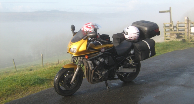 yamaha fazer loaded up with luggage on a hillside in the mist